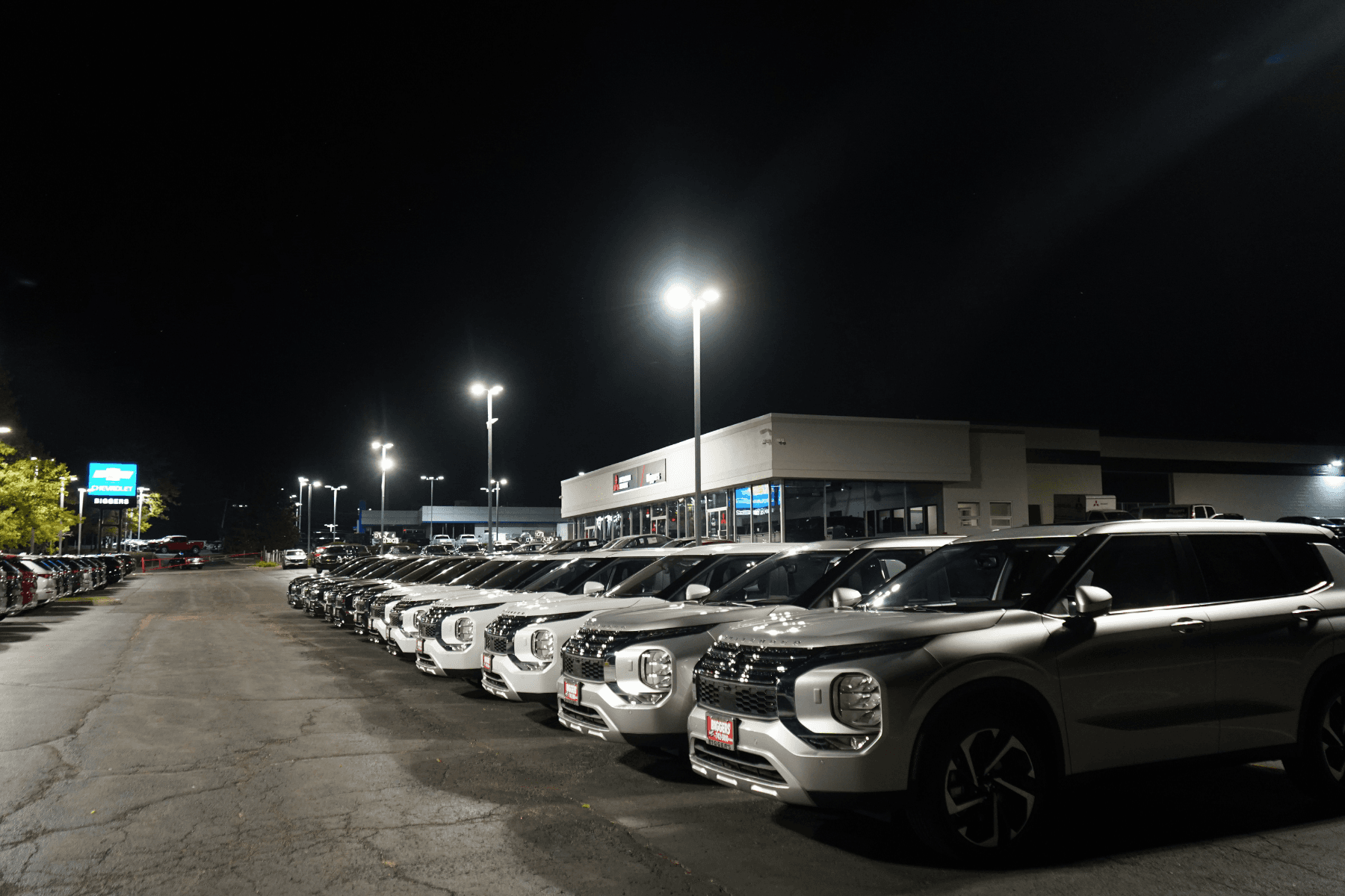 Commercial parking lot lighting at a dealership site at night